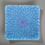 Sandcarved purple and cyan glass sun swimmer plate.