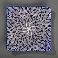 Sandcarved silver pearl and caribbean blue glass sun swimmer plate.