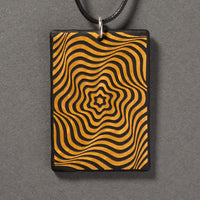 Sandcarved gold and black glass vortex pendant.