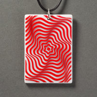 Sandcarved red and white glass vortex pendant.