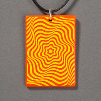 Sandcarved yellow and orange glass vortex pendant.